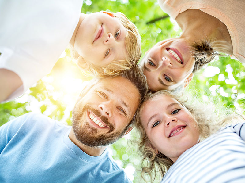 Image of a happy family smiling into the camera